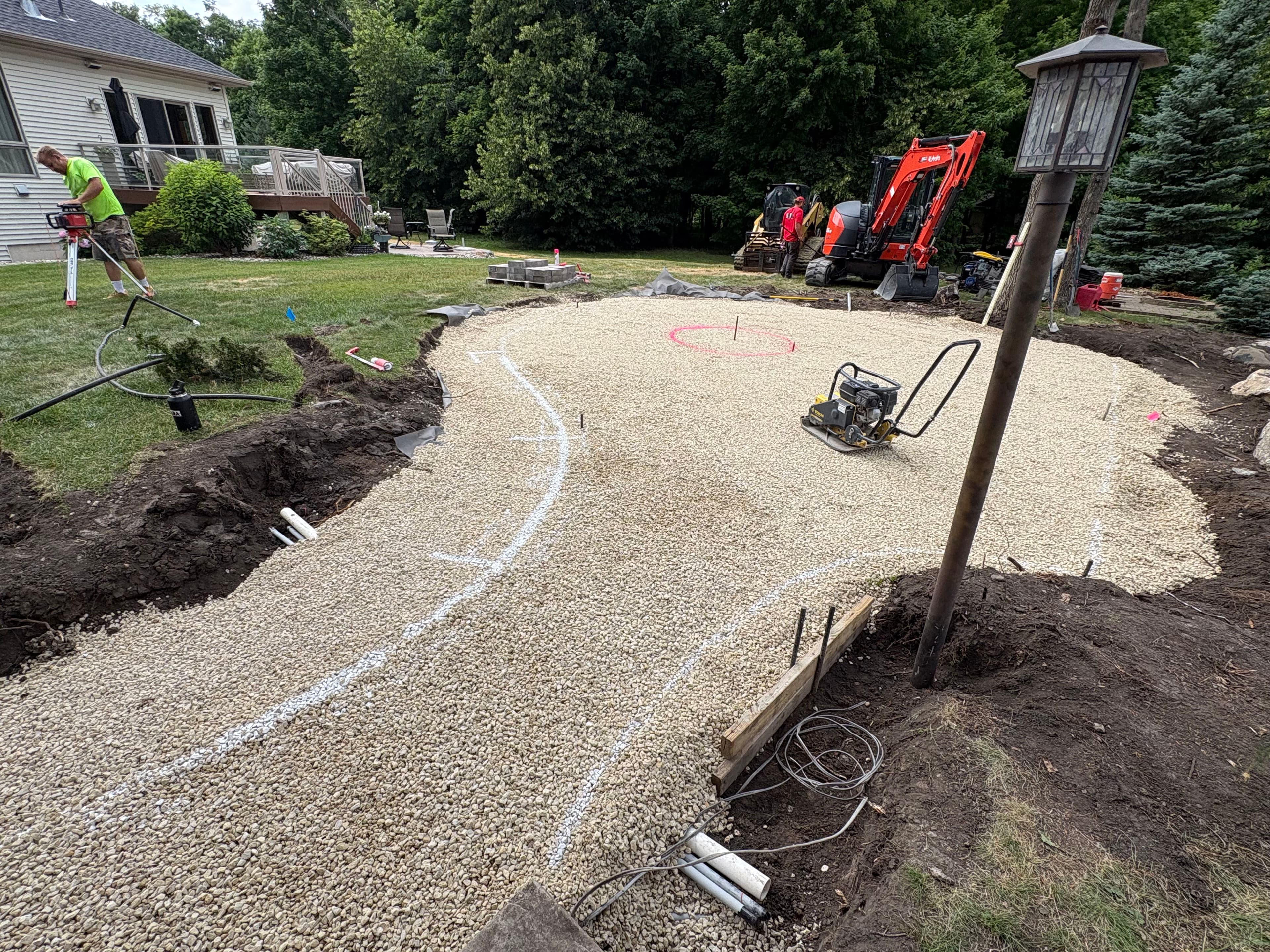 Project Cedar Lake Backyard Getting a Boulder Wall and Fire Pit Patio image