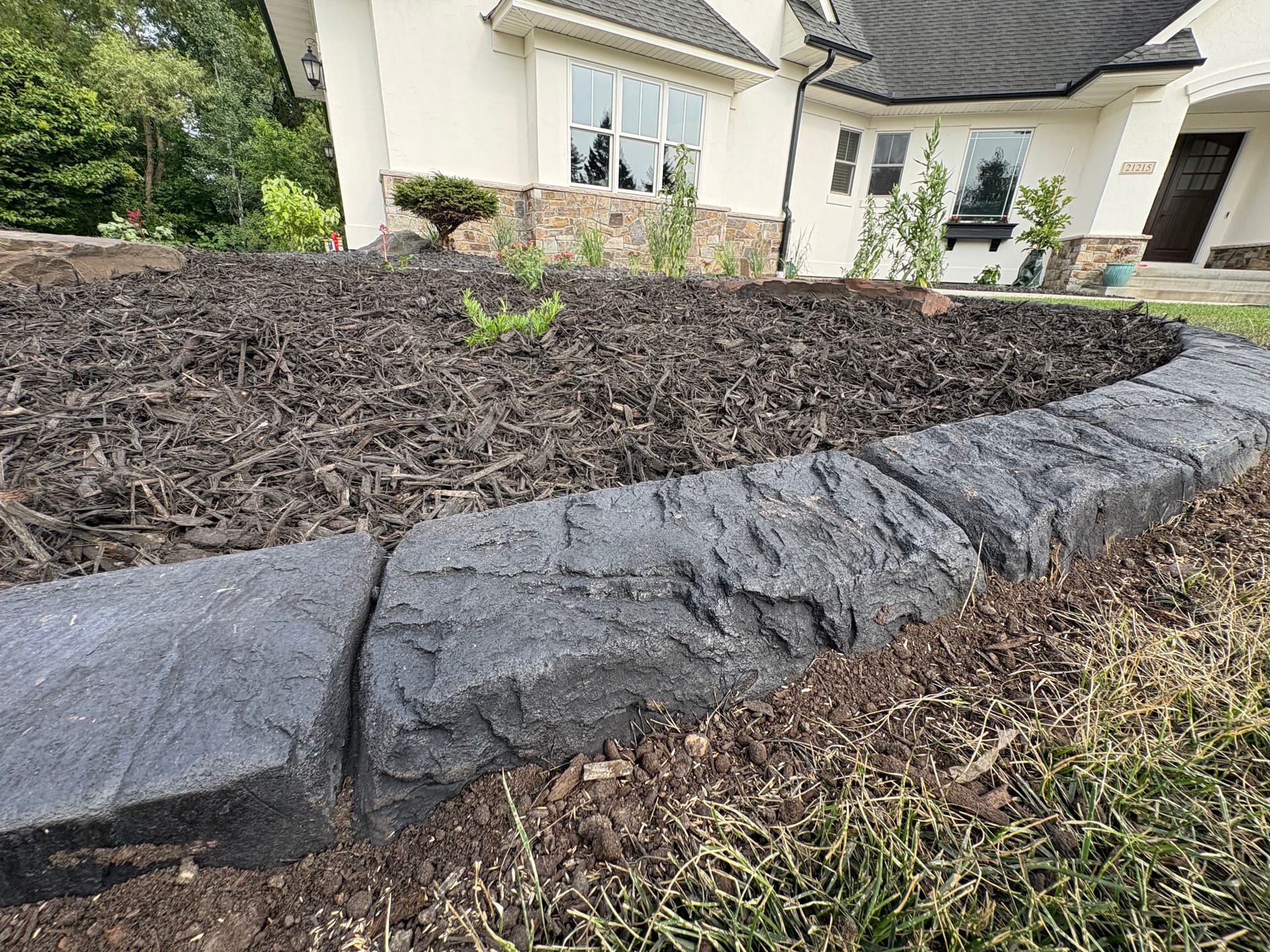 Custom Curbing and Fresh Mulch Give This Front Yard a Polished Edge image
