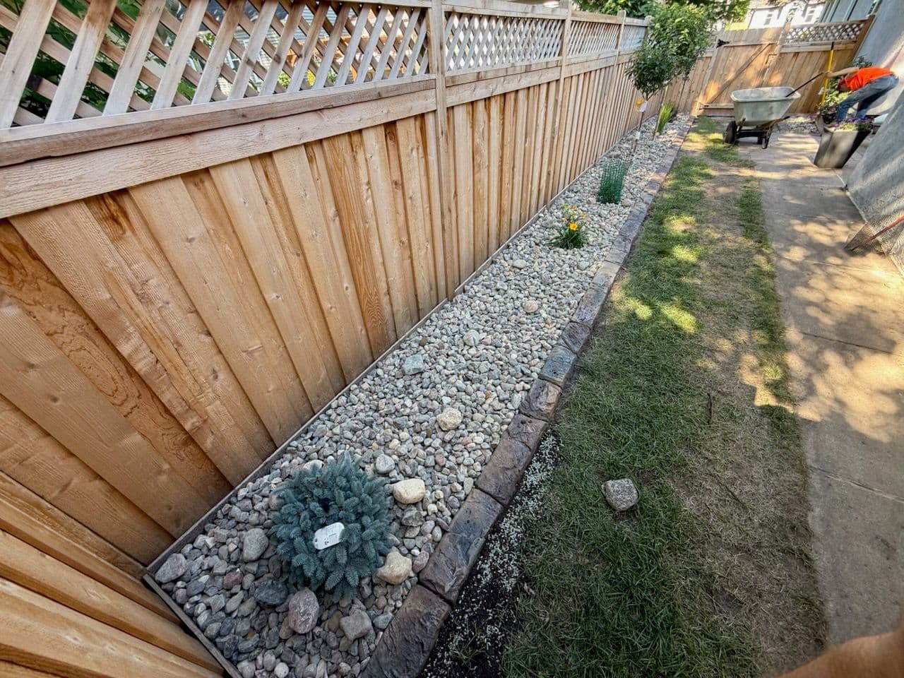 Expert Rock and Fence Installation in Backyard image
