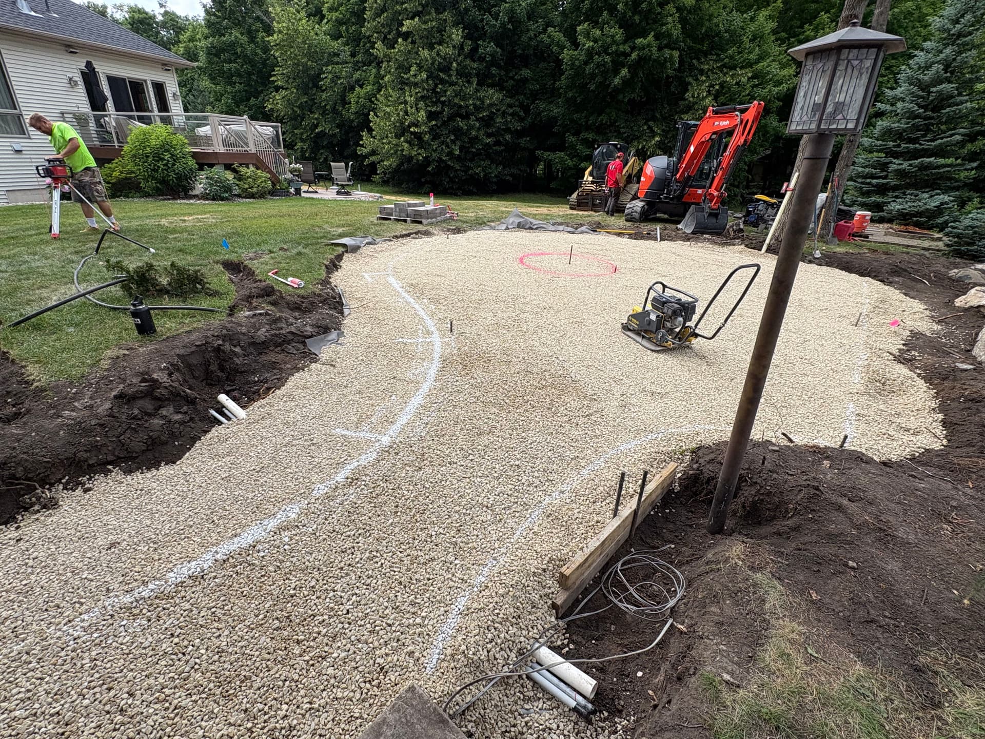 Cedar Lake Backyard Getting a Boulder Wall and Fire Pit Patio image