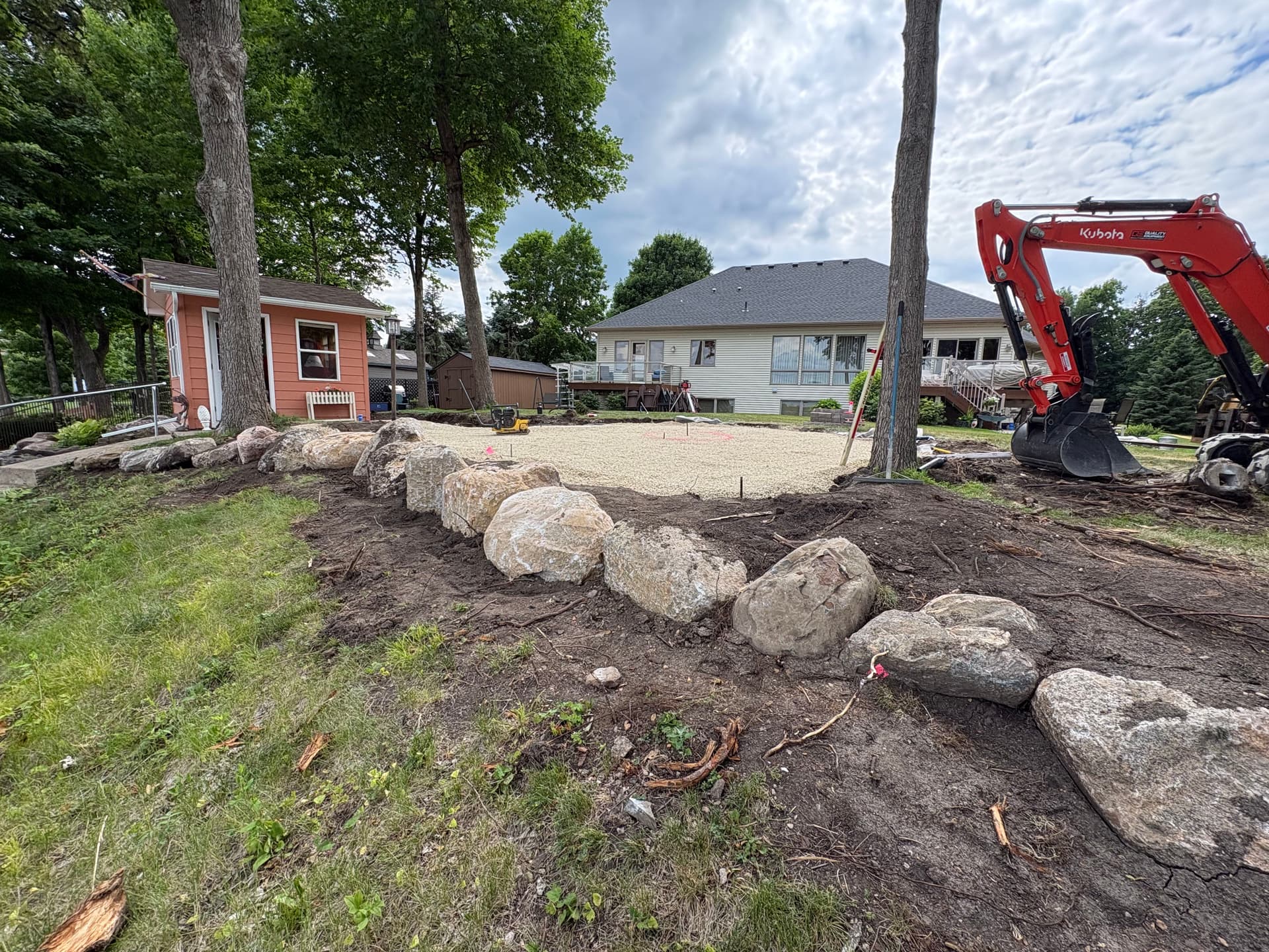 Gallery photos for Cedar Lake Backyard Getting a Boulder Wall and Fire Pit Patio: Image #3