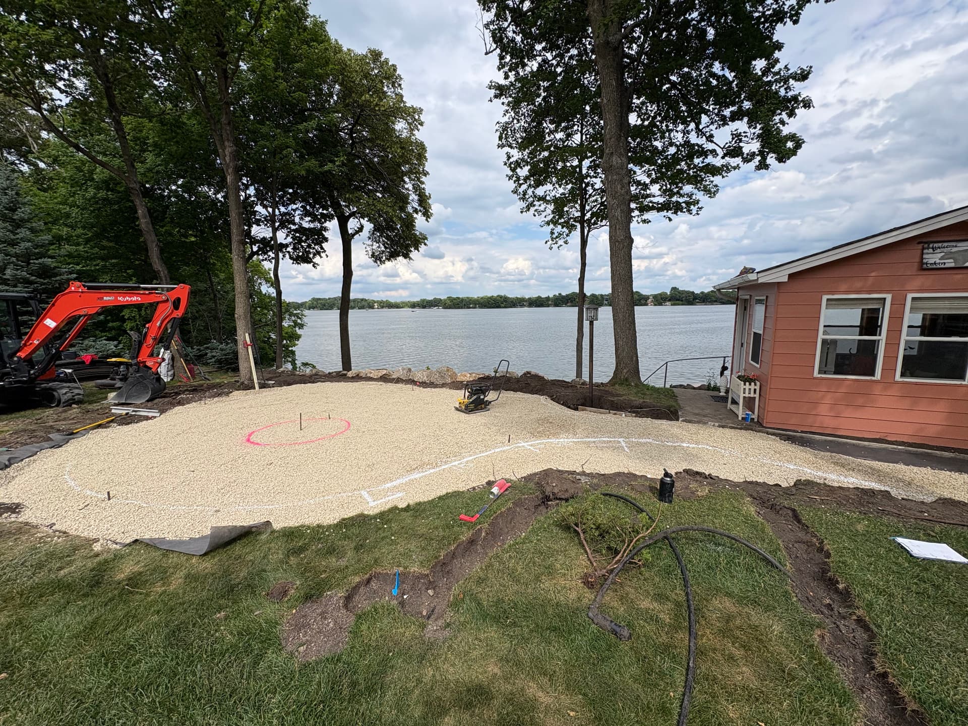 Gallery photos for Cedar Lake Backyard Getting a Boulder Wall and Fire Pit Patio: Image #1