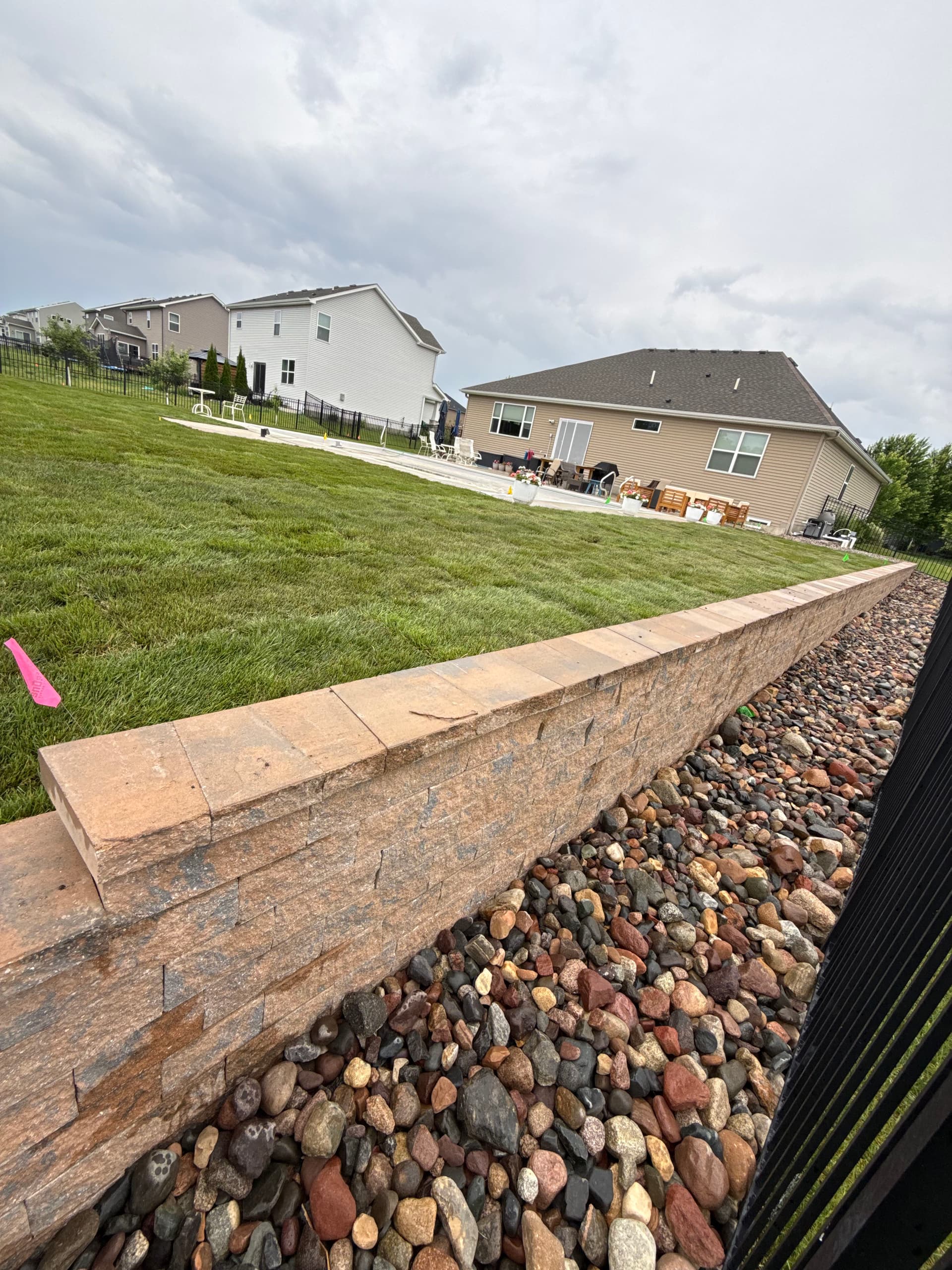 Backyard Overhaul With Sod, Rock, Retaining Wall and Pool Access Path image